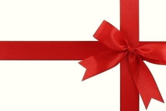 Red ribbon and bow on white background, forming a cross.